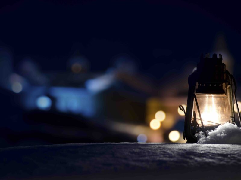 On the background of an ancient fortress old gas lamp is standing on the snow lighting up small area around. - Copyright (c) Mudretsov | Dreamstime.com